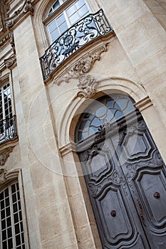 Weathered wooden door and wrought iron balcony