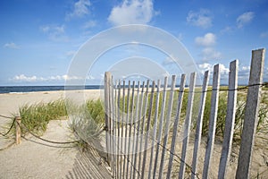 Weathered wooden fence on beach.