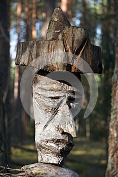 Weathered wooden sculpture in the middle of wilderness
