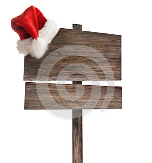 Weathered wooden sign with Santa hat on white