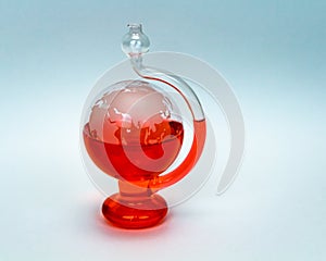 Weatherglass Globe Barometer isolated on White Background Red Water
