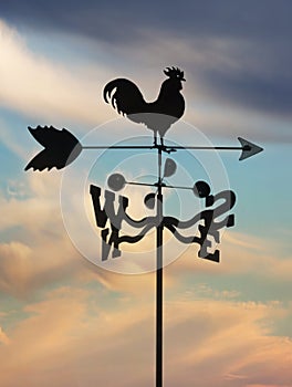 Weathervane against cloudscape