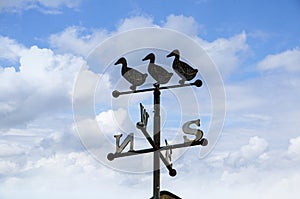 Weathervane by the Churchyard of All Hallows church in the village of Great Mitton, Lancashire photo