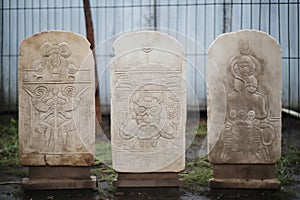 weatherworn stone tablets with engravings