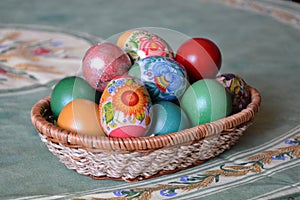 A weave basket with multicolored dyed eggs for Easter celebration