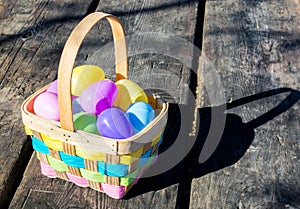 Wicker Easter basket filled with colorful eggs