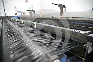 Weaving automatic machines - Weaving is a method of textile production in which two distinct sets of yarns or threads are