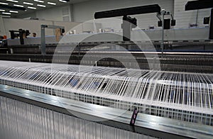 Weaving automatic machines - Weaving is a method of textile production in which two distinct sets of yarns or threads are