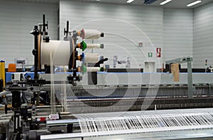 Weaving automatic machines - Weaving is a method of textile production in which two distinct sets of yarns or threads are