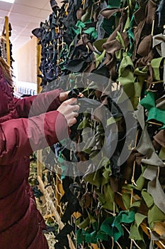 Weaving of camouflage nets made of fabric. Russian-Ukrainian war