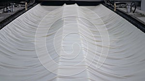 Weaving of fabric on cars. Production of fabric from threads at factory. Textile factory industry. Fabric making machines.