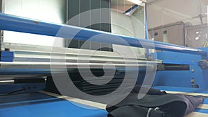 Weaving of fabric on cars. Production of fabric from threads at factory. Textile factory industry. Fabric making machines.