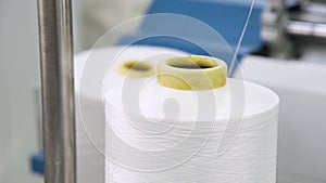 Weaving factory for the production of textile products. Large spools of thread in production
