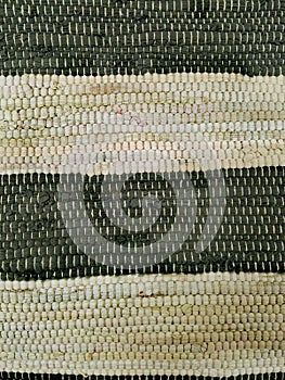 Weaving horizontal strakes.  White and black. Fragment of carpet.