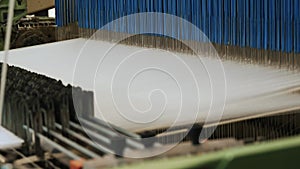 weaving loom. Close-up. industrial weaving loom machine in working process, at a textile factory. Weaving.