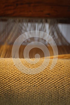 Weaving loom in rustic wool