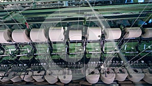 Weaving loom with spools and white threads