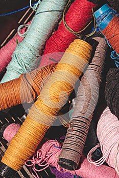 Weaving loom yarn reel. Close-up of spool of threads for looms