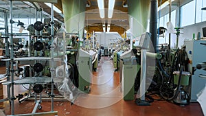 weaving looms. Textile factory. Many automated weaving machines working in the workshop. Weaving.