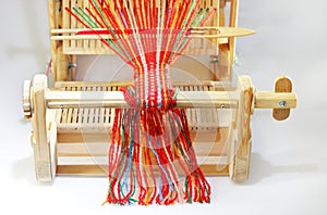 Weaving mini machine for making belts with patterns. Folk art, handmade. Detail.