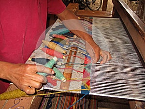 Weaving with an old traditional loom, Teotitlan, Mexiko