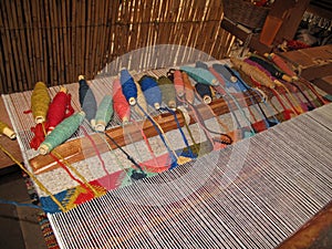 Weaving with an old traditional loom, Teotitlan, Mexiko photo