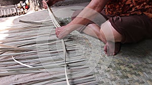 Weaving reed mat by old asian woman hand , handmade thai style