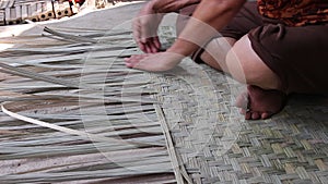 Weaving reed mat by old asian woman hand , handmade thai style