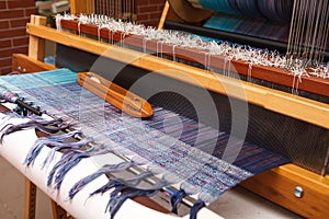 Weaving shuttle on the blue warp in weaving machine