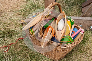 Weaving shuttles and multi-colored yarn in a basket