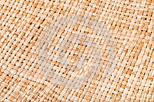 Weaving of straw hat from natural raffia fibers photo