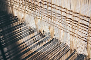 Weaving threads inside the loom