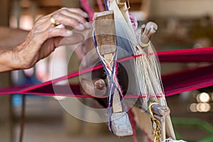 Weaving. Woman hand weaving on manual loom. Fabric handmade. Homespun fabric process. The process of fabric weaving in vintage