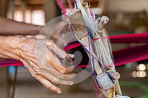 Weaving. Woman hand weaving on manual loom. Fabric handmade. Homespun fabric process. The process of fabric weaving in vintage