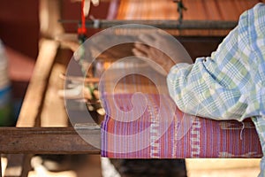 Weaving. Woman hand weaving on manual loom. Fabric handmade. Homespun fabric process. The process of fabric weaving in vintage