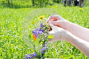 Weaving a wreath of wild flowers