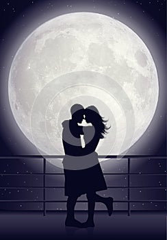 Couple kissing in moonlight photo