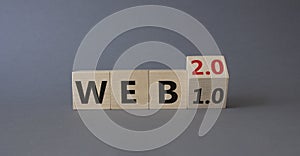 WEB 2 or 1 symbol. Turned wooden cubes with words WEB 1.0 or WEB 2.0. Beautiful grey background. Business and WEB concept. Copy