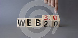 Web 3.0 vs Web 2.0 symbol. Finger points at cubes with the words web 3.0 and web 2.0. Beautiful orange background. Businessman