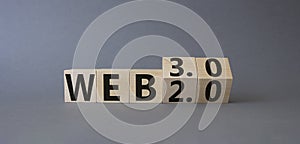 Web 3.0 vs Web 2.0 symbol. Turned cubes with the words web 3.0 and web 2.0. Beautiful grey background. Businessman hand. Business