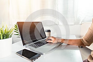 Programmer woman writing program code sitting at workplace in office
