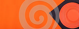 Web banner with clay target on black and orange