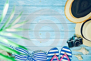 web banner flat lay summer time with swimsuit and beach accessories on blue wooden background