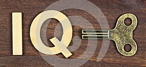 Intelligence quotient, iq test concept, winding key with letters on a wooden background photo