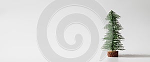 Web Banner Miniature christmas tree on white background with copy space for text. Winter holiday celebration concept