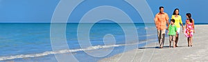 Web banner panoramic happy family of mother, father and two children, son and daughter, walking on a beach