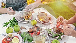 Web banner. People eat at the table with wine, grilled fish, fresh vegetables and herbs. Horizontal shot