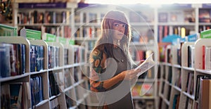 Web banner of shopping books. Side view of Caucasian woman with tattoo holds book in bookstore. Copy space. Concept of