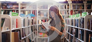 Web banner of shopping books. Side view of pretty Caucasian woman with tattoo reading book in bookstore. Copy space