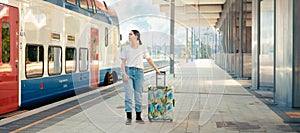 Web banner of travel. Young woman holding her luggage and waiting departure. Train station is in background. Concept of